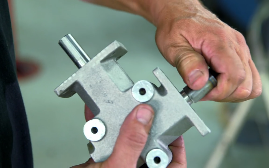 Two hands turning a shaft on a MITRPAK right angle gearbox