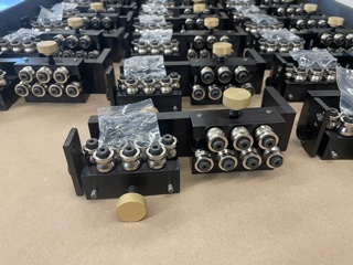 Close detail of wire straightener assemblies on a cart following machining and assembly operations.