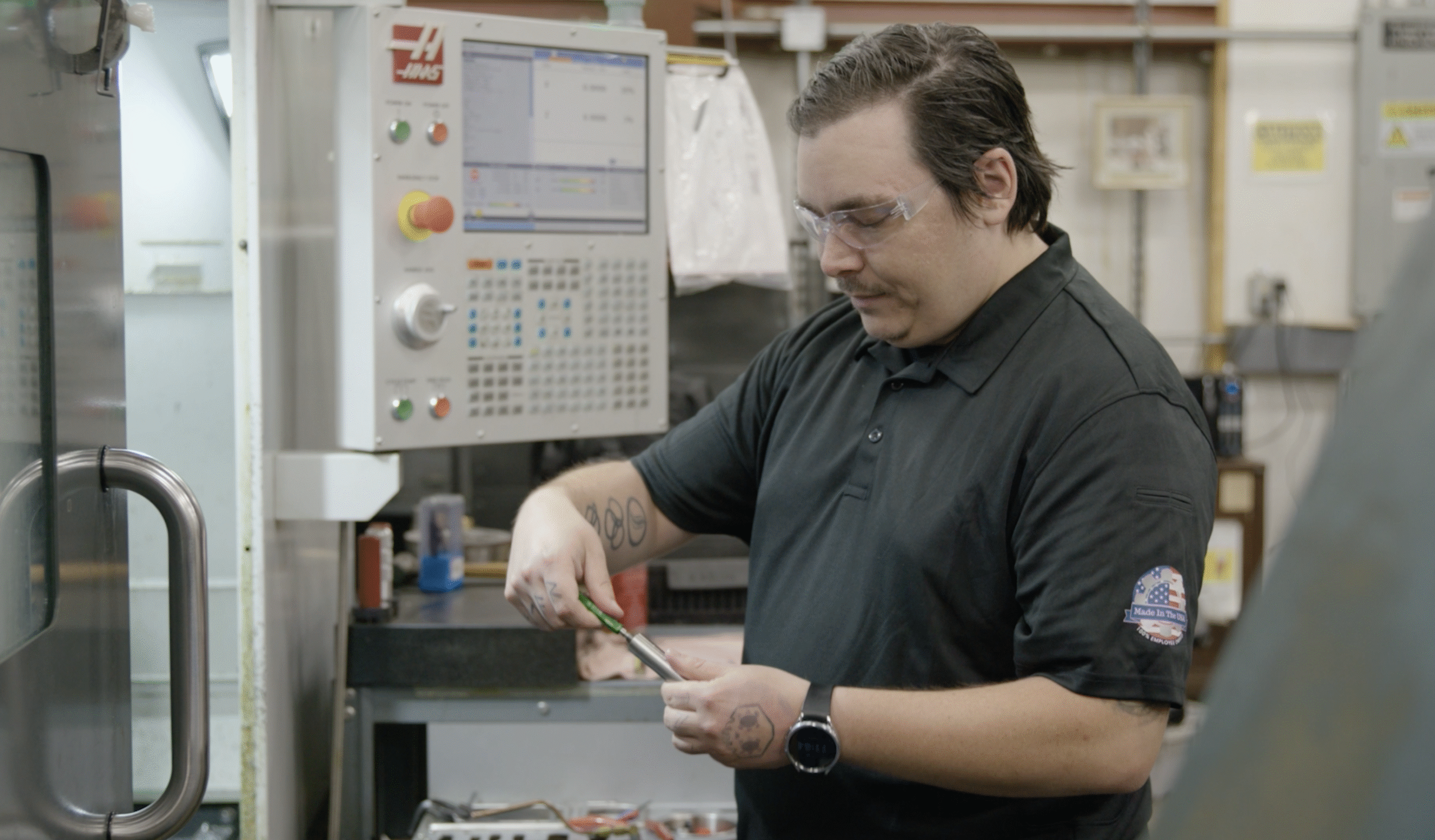 Zach works at his station as a proud employee-owner at Lampin, representing the second generation of his family to build a career on the shop floor.